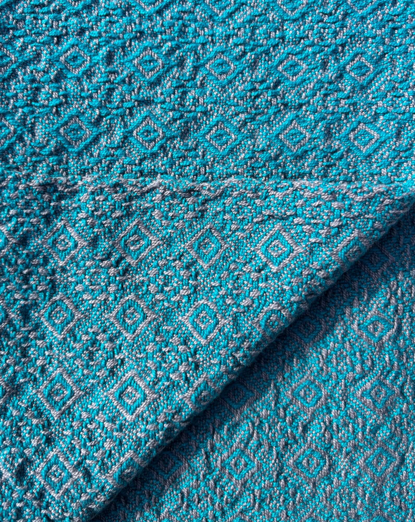 Towel woven in bright blue on grey in a diamond and brocade pattern
