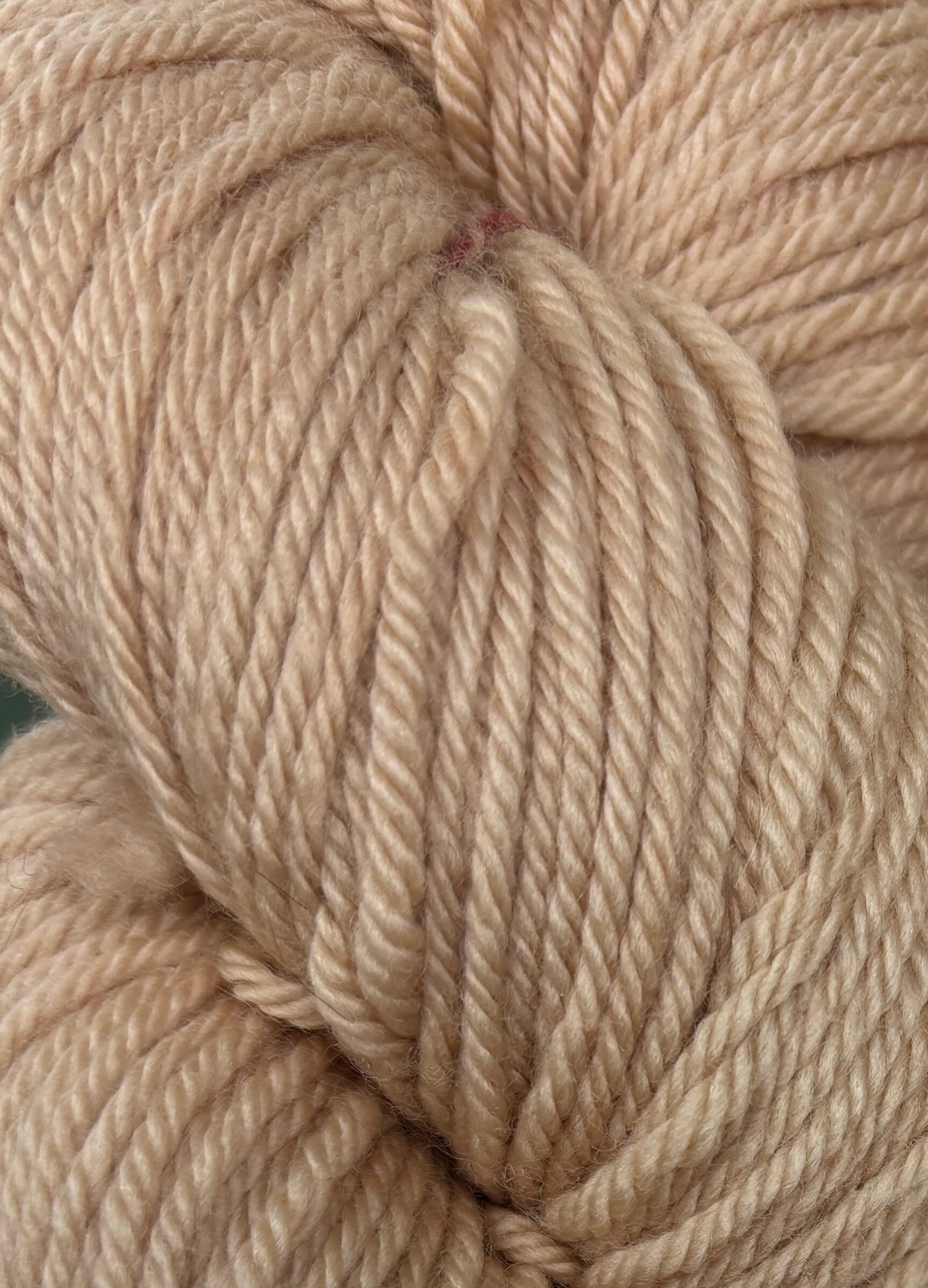 Close-up of rose gold yarn skein