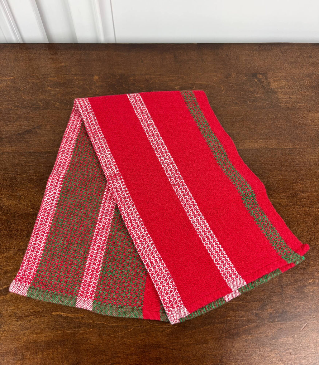 Red, white and green towel on a wooden surface