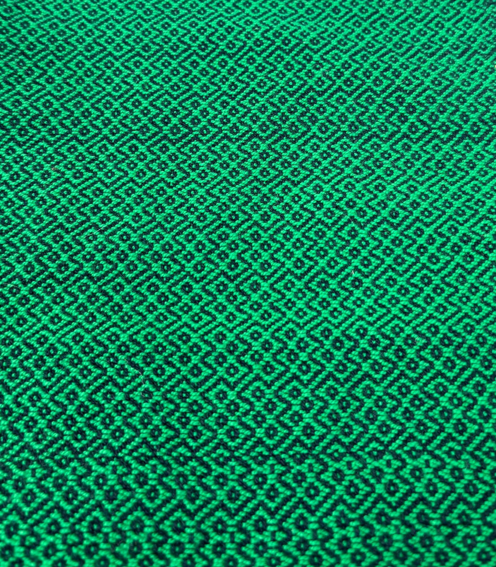 Green fabric texture with a geometric pattern