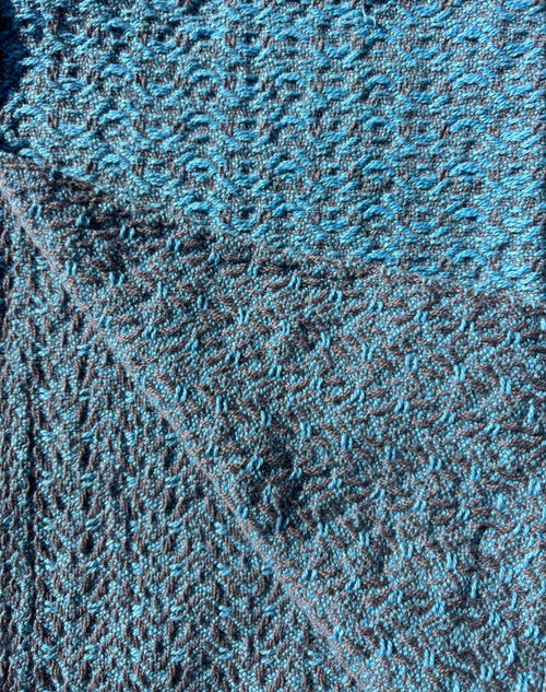 Towel woven with light blue yarn on grey in a brocade pattern