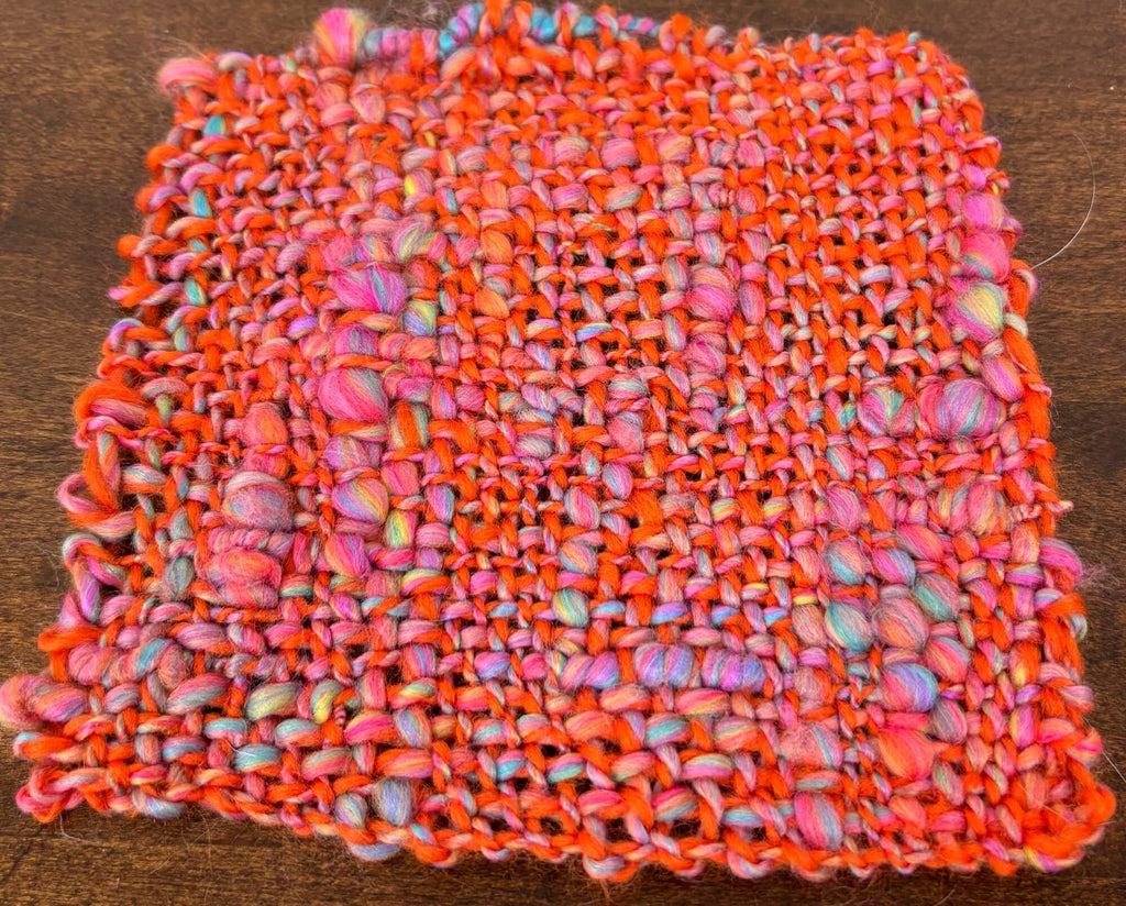 Multicolored woven fabric on a wooden surface