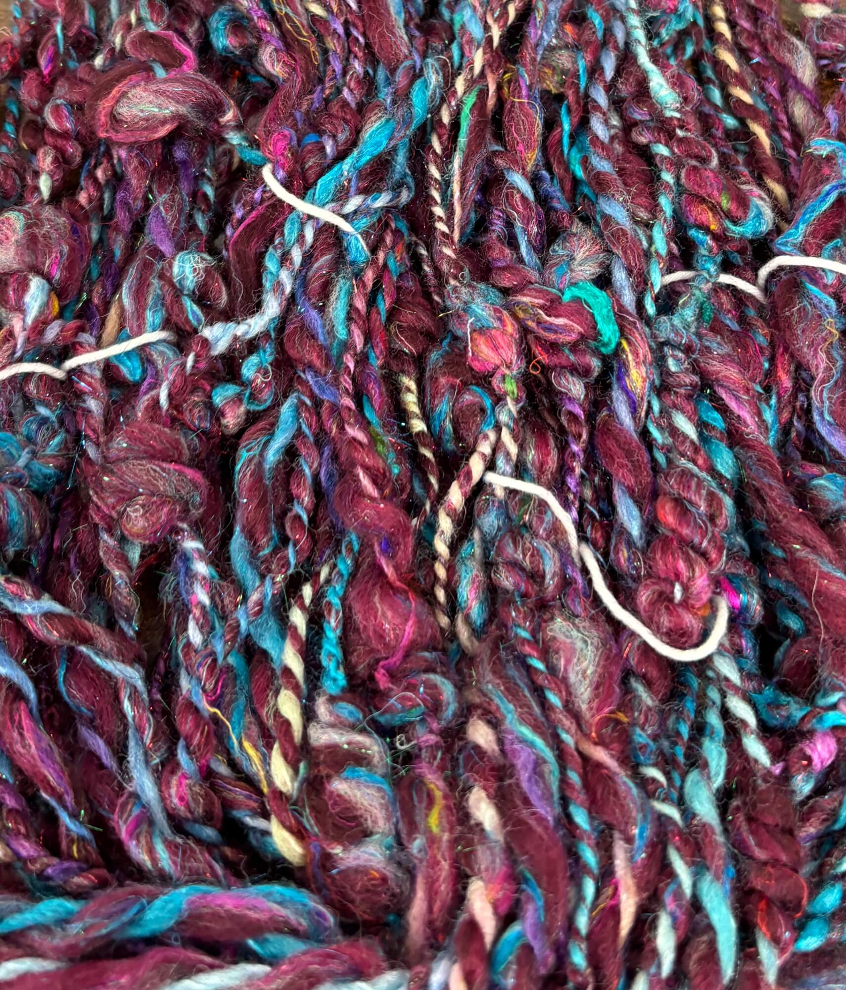 Close-up of multicolored purple and blue yarn with a focus on texture and color.
