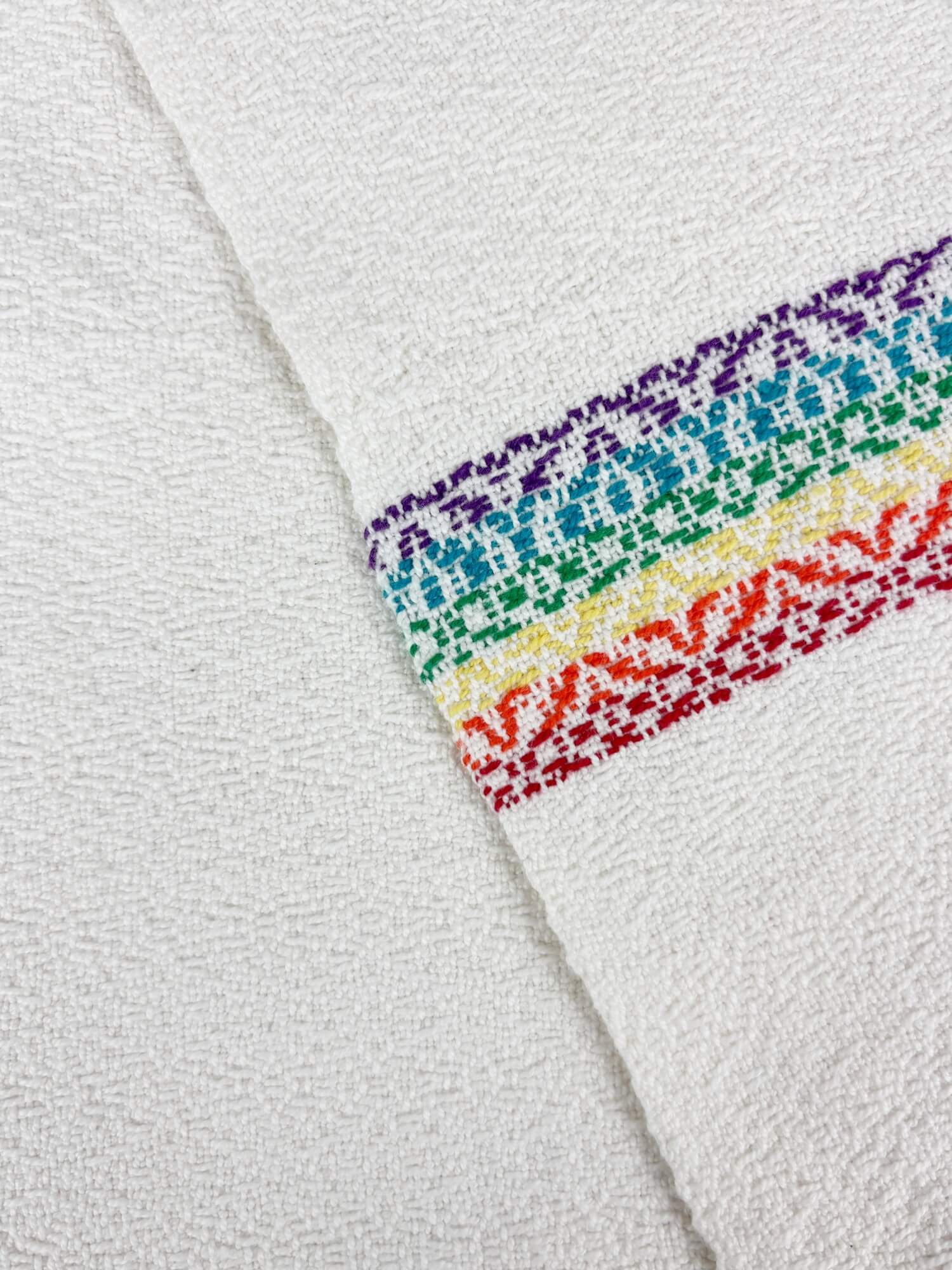 Close-up of a white towel with a rainbow stripe