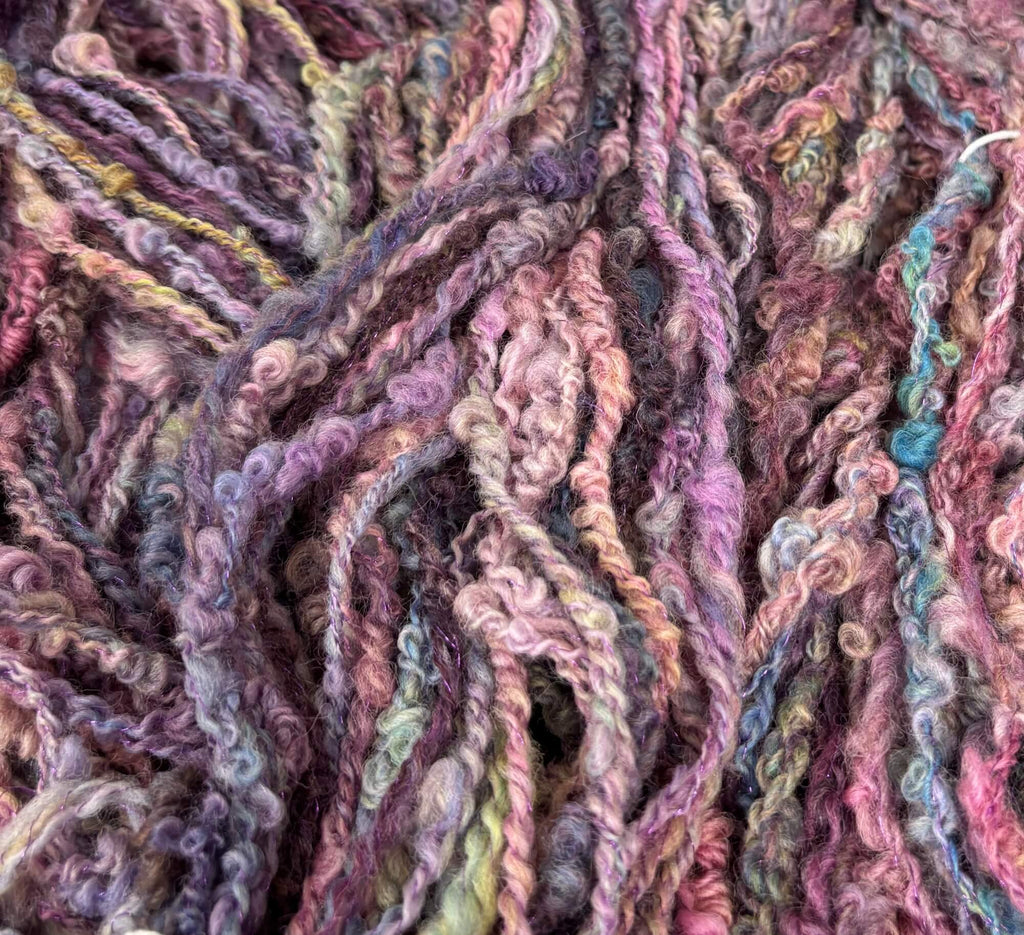 Close-up of multicolored purple yarn strands with a unique texture